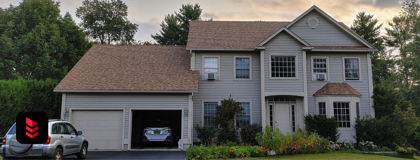 Two-story home with new tan Owens Corning Brownwood roof by RoofPros.Plus